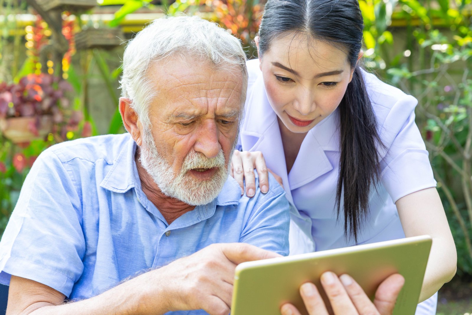 Nurse,Help,Senior,Retirement,Man,Working,With,Laptop,In,Backyard